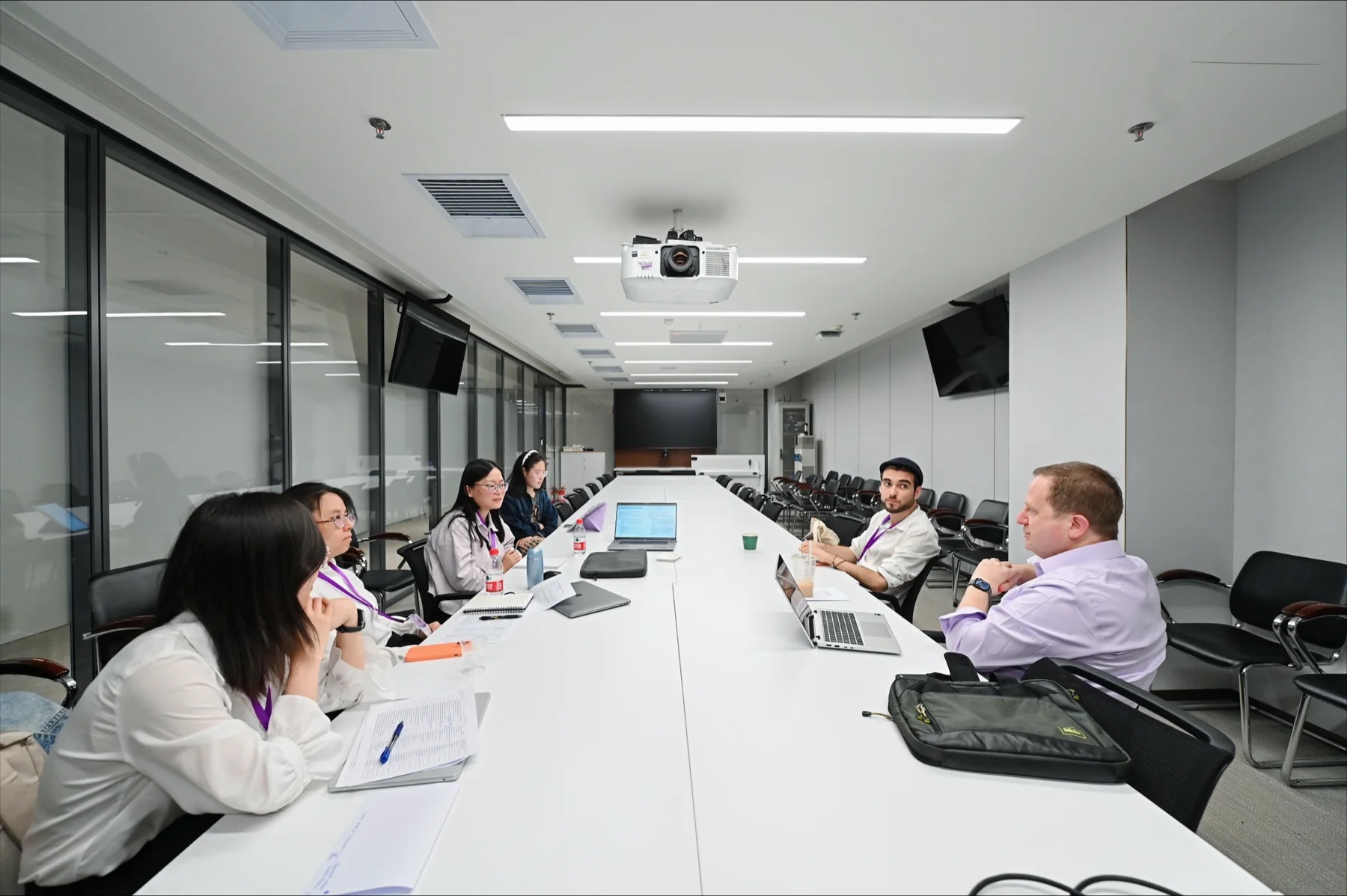 Small-group paper-development discussion around a conference table